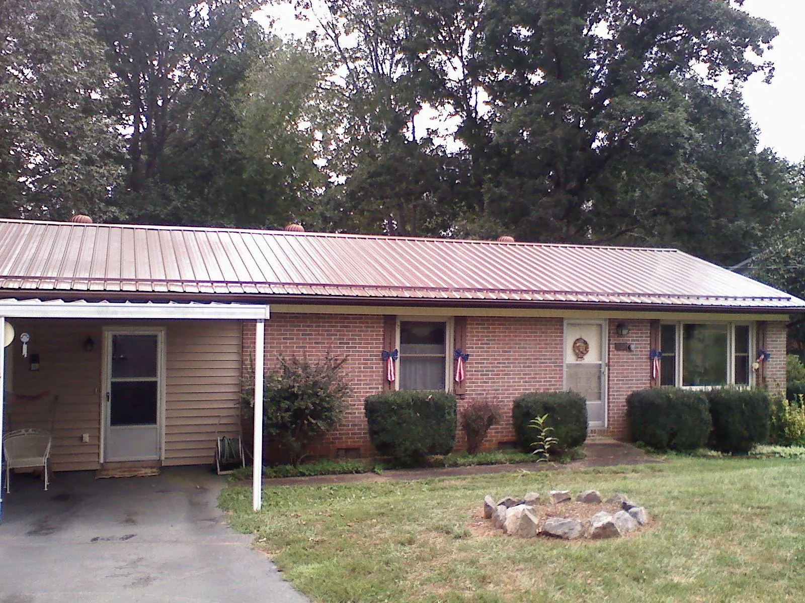 Bronze metal roof and carport on a brick ranch home — Roof Repair work by our crew in Mount Ephraim